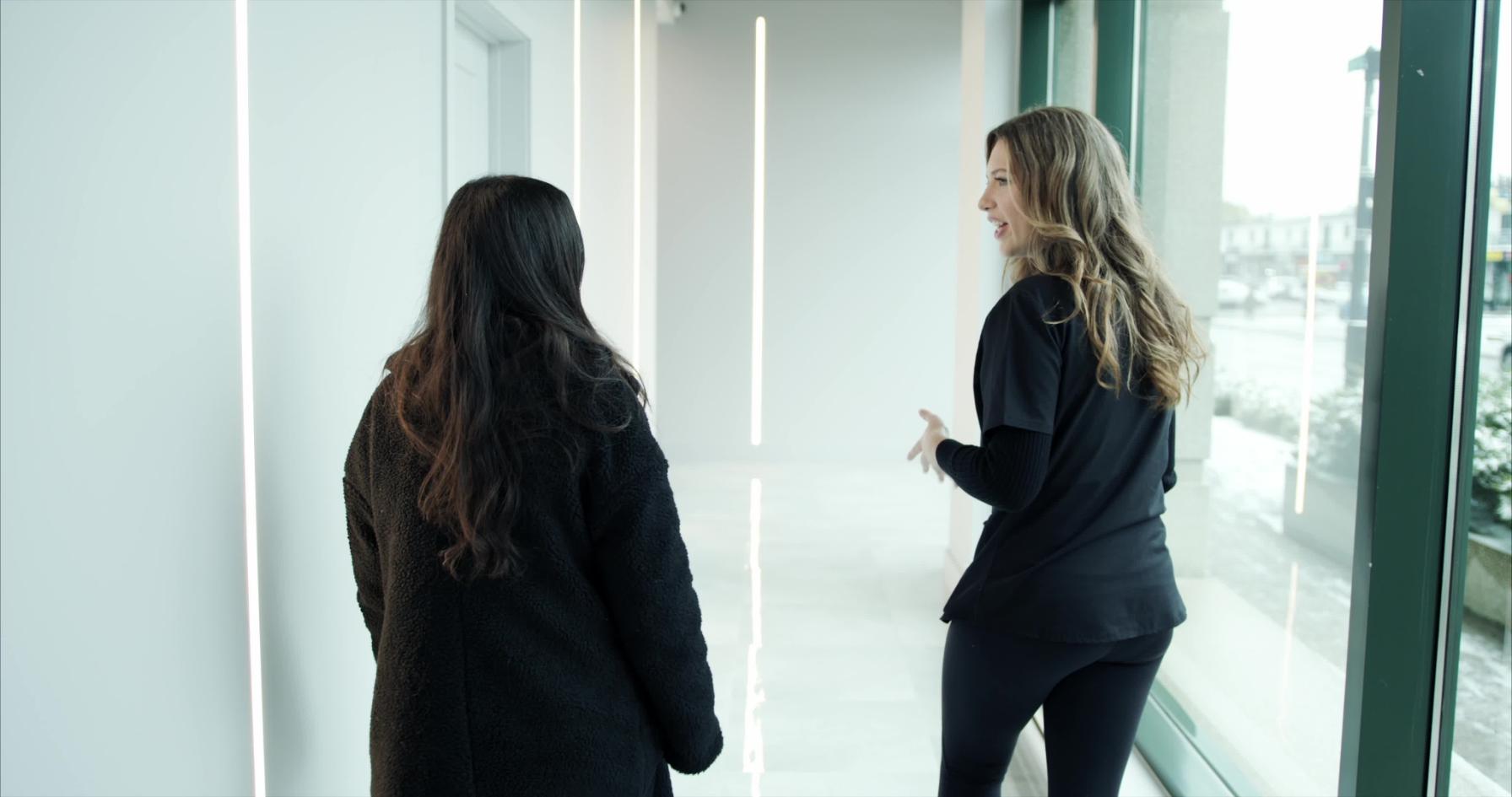esthetician guiding her client in the hallway of new age spa montreal or laval